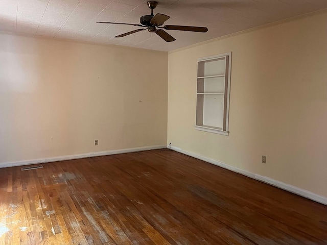 unfurnished room with crown molding, built in features, ceiling fan, and dark hardwood / wood-style flooring