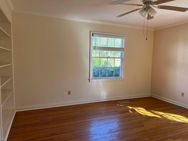 empty room with a ceiling fan, baseboards, ornamental molding, and wood finished floors