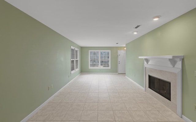 unfurnished living room featuring light tile patterned floors and a fireplace