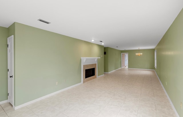 unfurnished living room featuring a notable chandelier and a high end fireplace