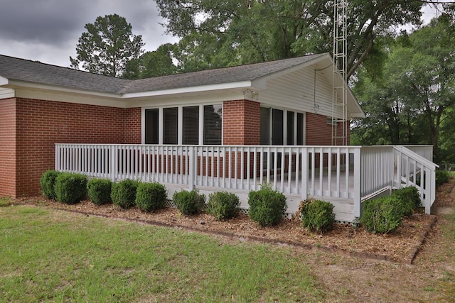 1222 E Main St, Ariton, AL 36311 - view of side of home featuring brick siding, a wooden deck, and a yard