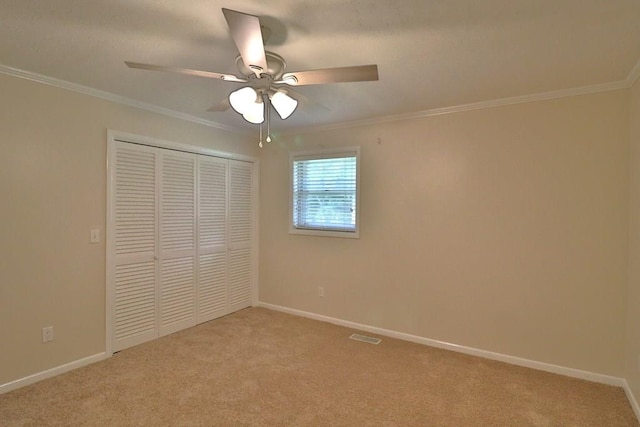1222 E Main St, Ariton, AL 36311 - unfurnished bedroom featuring light carpet, a closet, crown molding, and a ceiling fan
