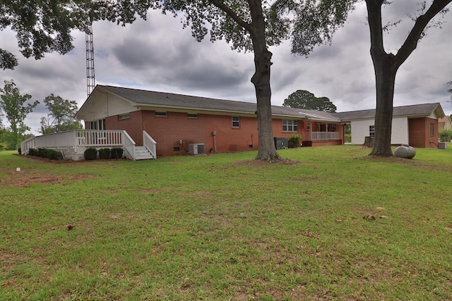 1222 E Main St, Ariton, AL 36311 - rear view of house with a wooden deck, a lawn, and brick siding