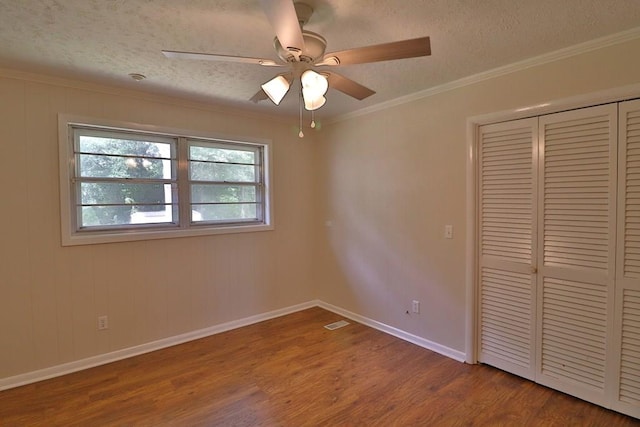 1222 E Main St, Ariton, AL 36311 - unfurnished bedroom featuring wood finished floors, a closet, a textured ceiling, crown molding, and ceiling fan