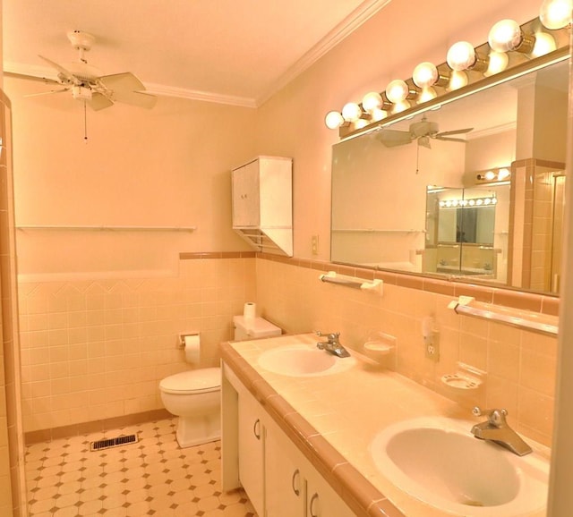 1222 E Main St, Ariton, AL 36311 - bathroom featuring ornamental molding, a ceiling fan, tile walls, double vanity, and a wainscoted wall