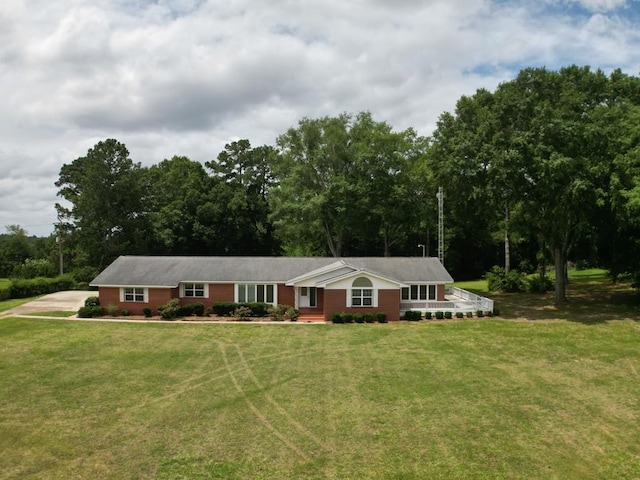 ranch-style home featuring a front yard