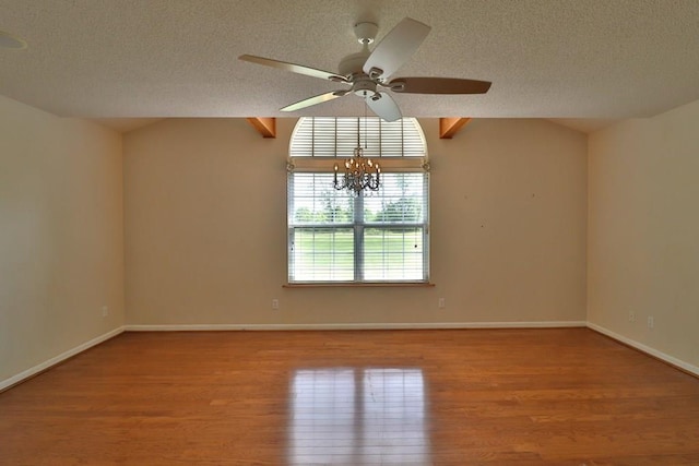 1222 E Main St, Ariton, AL 36311 - spare room featuring a textured ceiling, wood finished floors, a chandelier, and ceiling fan