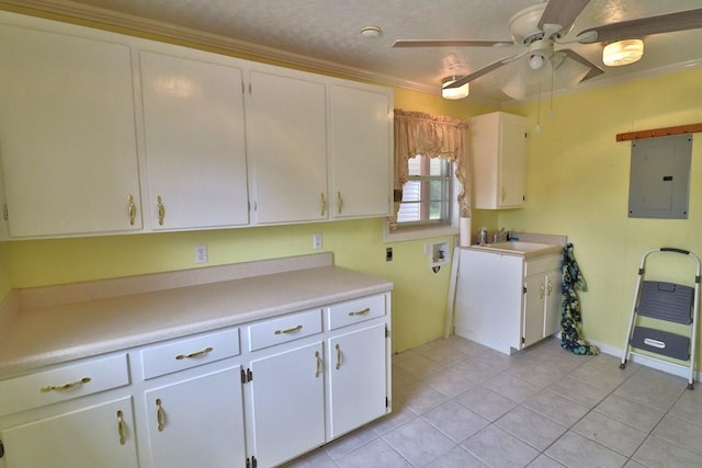 1222 E Main St, Ariton, AL 36311 - kitchen with electric panel, ceiling fan, light countertops, light tile patterned floors, and crown molding