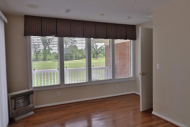 1222 E Main St, Ariton, AL 36311 - empty room featuring heating unit and wood finished floors