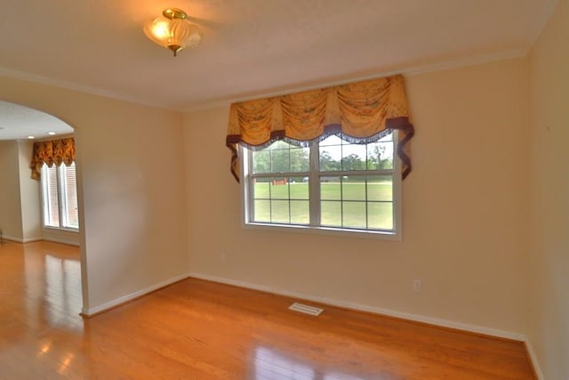 1222 E Main St, Ariton, AL 36311 - unfurnished room with arched walkways, wood finished floors, and crown molding