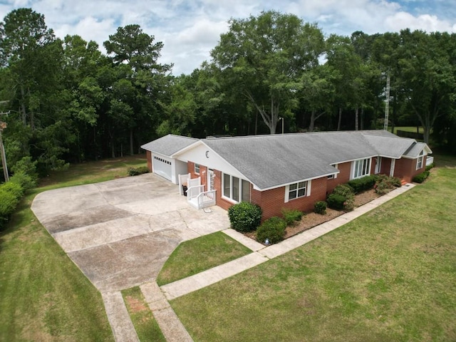 1222 E Main St, Ariton, AL 36311 - ranch-style home with concrete driveway, brick siding, a front yard, a garage, and roof with shingles