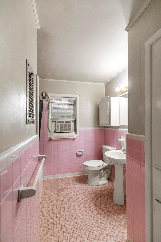 1104 Valley Forge Rd, Dothan, AL 36301 - bathroom with tile walls, cooling unit, toilet, a wainscoted wall, and a sink