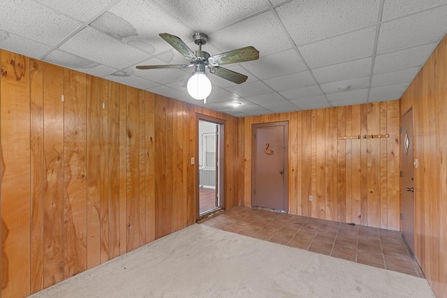 1104 Valley Forge Rd, Dothan, AL 36301 - spare room featuring a paneled ceiling, wooden walls, carpet, and ceiling fan