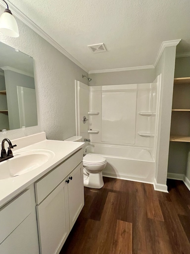 bathroom featuring shower / bathtub combination, visible vents, toilet, a textured ceiling, and wood finished floors