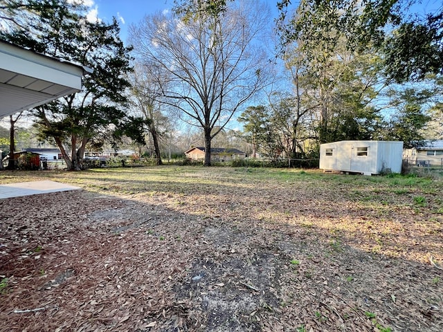 view of yard with a storage unit and an outdoor structure