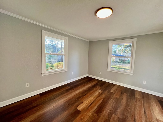 unfurnished room with ornamental molding, dark wood-style flooring, and baseboards