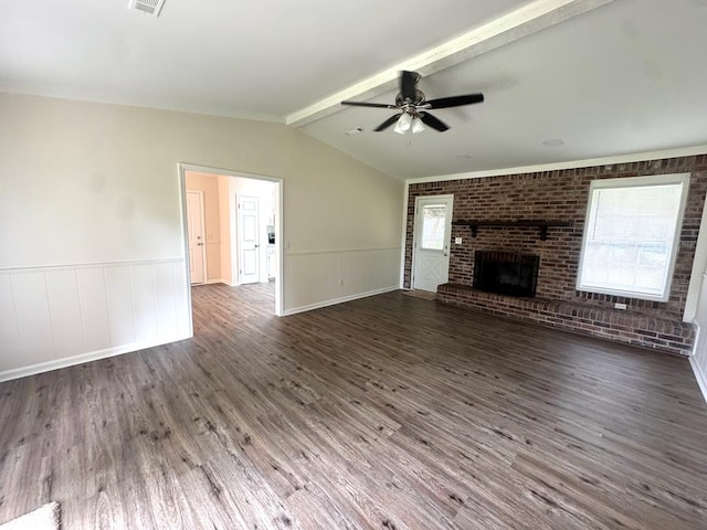1905 Shamrock Rd, Dothan, AL 36301 - unfurnished living room with wood finished floors, healthy amount of natural light, a wainscoted wall, a ceiling fan, and brick wall