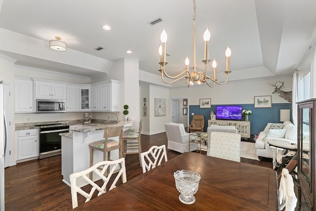 538 Orchard, Dothan, AL 36305 - dining space featuring a chandelier, dark wood-style floors, recessed lighting, and a raised ceiling