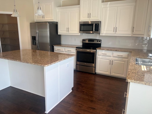 101 Brattleboro Ct, Dothan, AL 36301 - kitchen featuring appliances with stainless steel finishes, dark wood-style floors, white cabinets, and decorative backsplash
