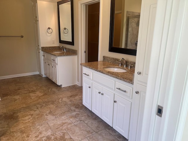 101 Brattleboro Ct, Dothan, AL 36301 - full bathroom featuring two vanities, stone finish floors, a stall shower, and a closet