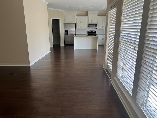 101 Brattleboro Ct, Dothan, AL 36301 - kitchen featuring appliances with stainless steel finishes, crown molding, a center island, dark wood-type flooring, and decorative light fixtures