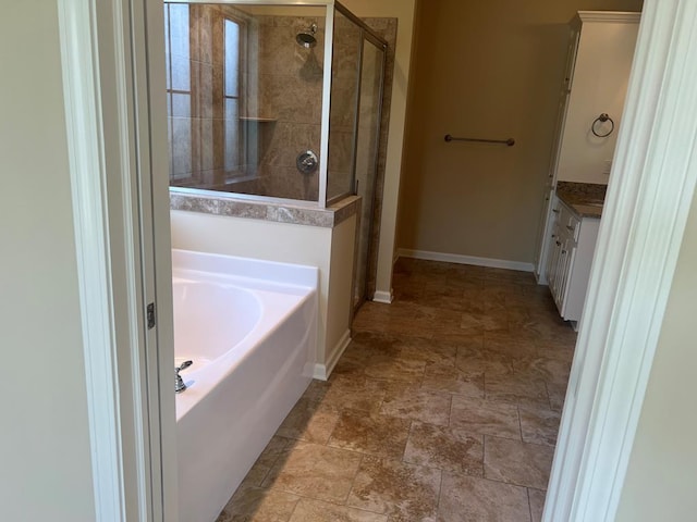 101 Brattleboro Ct, Dothan, AL 36301 - full bathroom with tiled shower, a garden tub, vanity, and stone finish floors