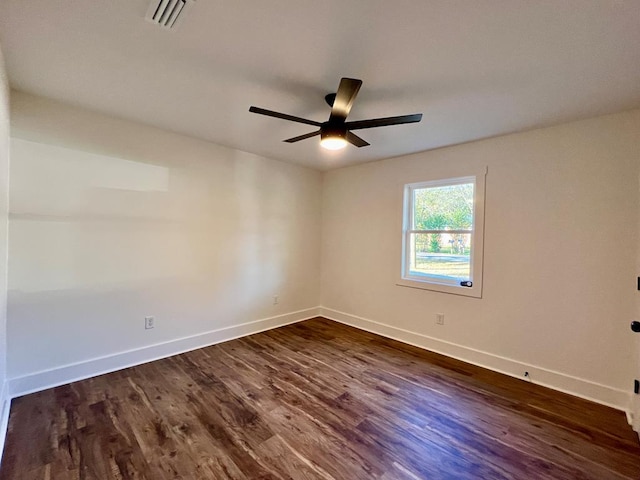 spare room featuring ceiling fan and dark hardwood / wood-style flooring