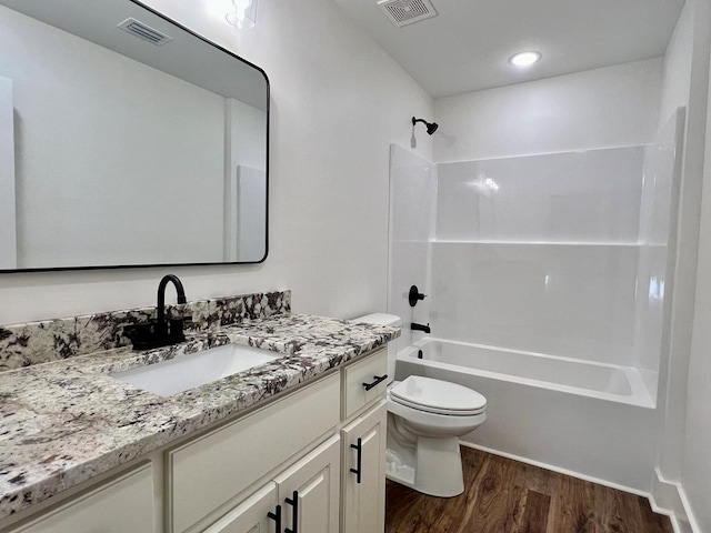 full bathroom with vanity, hardwood / wood-style flooring, toilet, and shower / bathtub combination