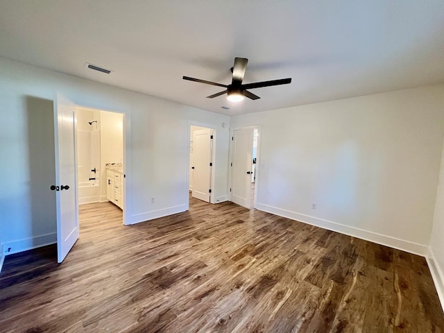 unfurnished bedroom featuring connected bathroom, ceiling fan, and hardwood / wood-style floors