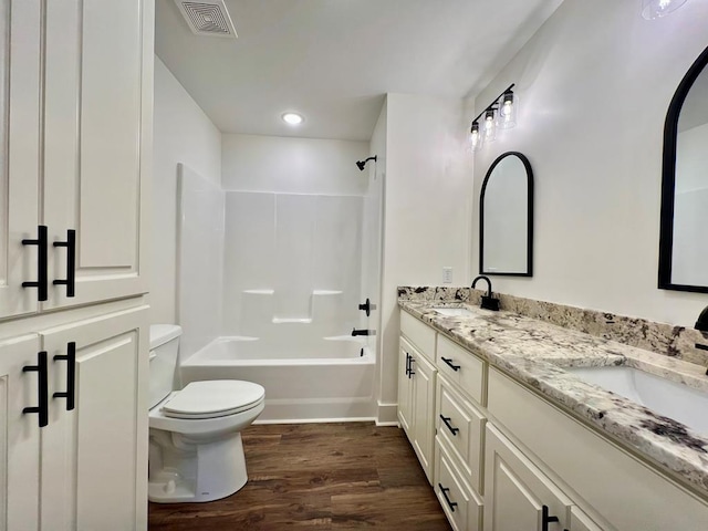 full bathroom with vanity, shower / bathtub combination, toilet, and wood-type flooring