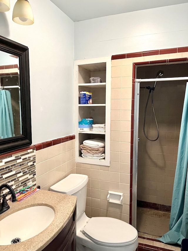 bathroom featuring a shower with curtain, vanity, tile walls, and toilet