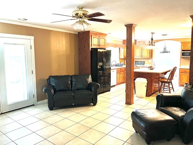 living room featuring a textured ceiling, ceiling fan with notable chandelier, crown molding, and light tile patterned flooring