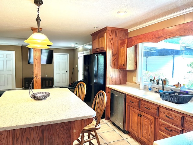 kitchen featuring dishwasher, sink, crown molding, black refrigerator, and light tile patterned floors