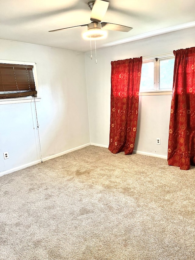 empty room featuring ceiling fan and carpet floors