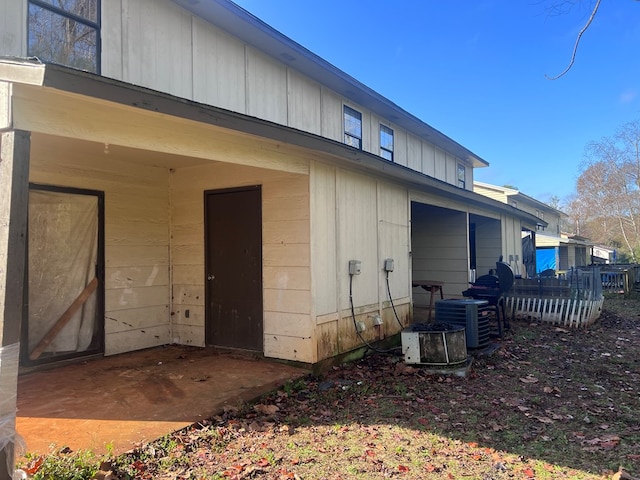 back of house with central AC unit