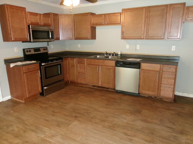 202 Cardinal Ln, Enterprise, AL 36330 - kitchen with stainless steel appliances, crown molding, dark wood-style flooring, and dark countertops