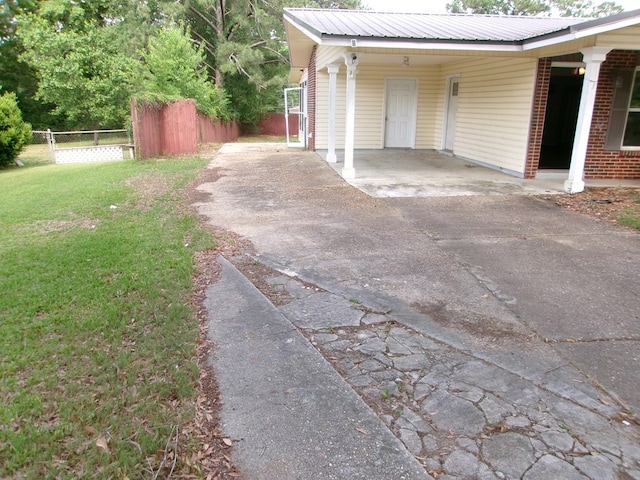 202 Cardinal Ln, Enterprise, AL 36330 - view of side of home featuring driveway, an attached carport, and a metal roof