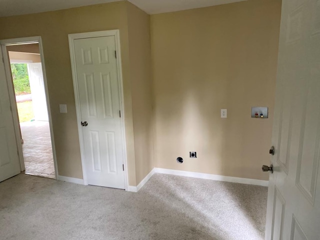 clothes washing area featuring light carpet, washer hookup, and electric dryer hookup