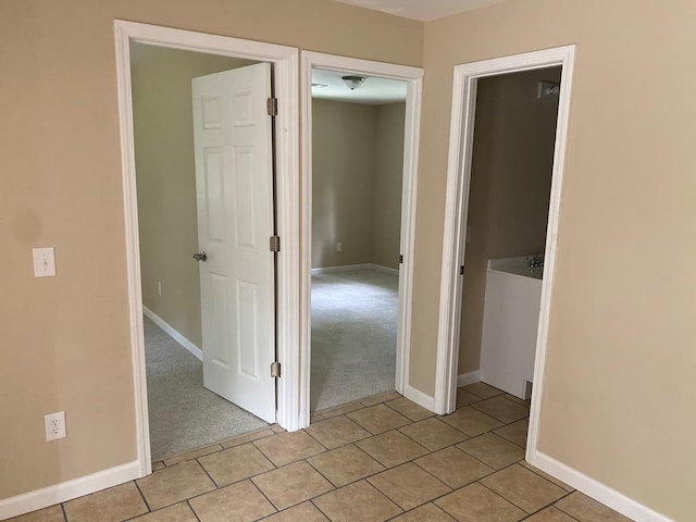 hallway featuring light carpet