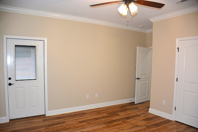 unfurnished room with dark wood-style flooring, crown molding, visible vents, a ceiling fan, and baseboards