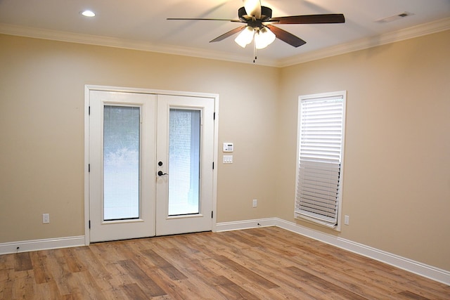 entryway featuring light wood finished floors, baseboards, visible vents, ornamental molding, and french doors