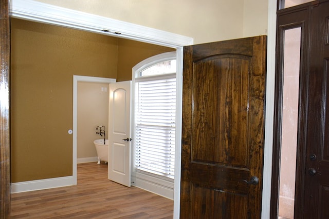 entrance foyer featuring light wood-style floors and baseboards