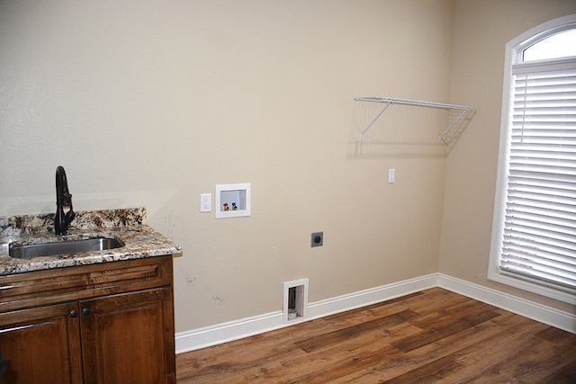 laundry area featuring dark wood finished floors, hookup for a washing machine, visible vents, a sink, and electric dryer hookup