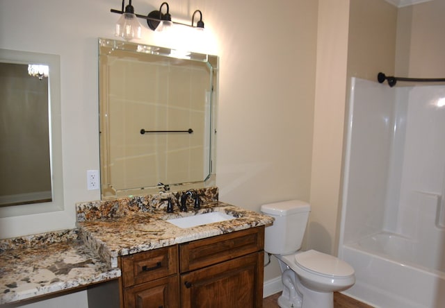 full bathroom with  shower combination, vanity, and toilet