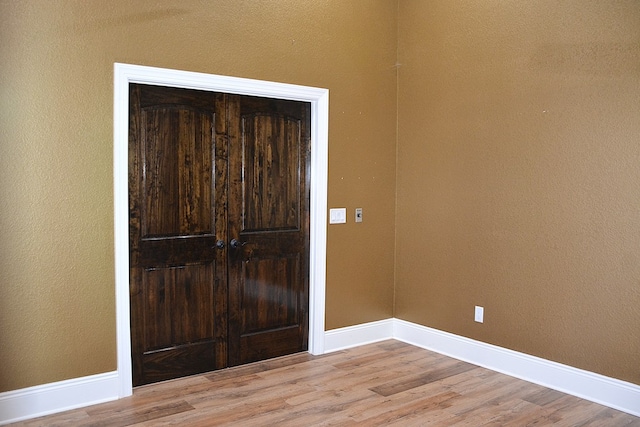 foyer with light wood-style floors and baseboards