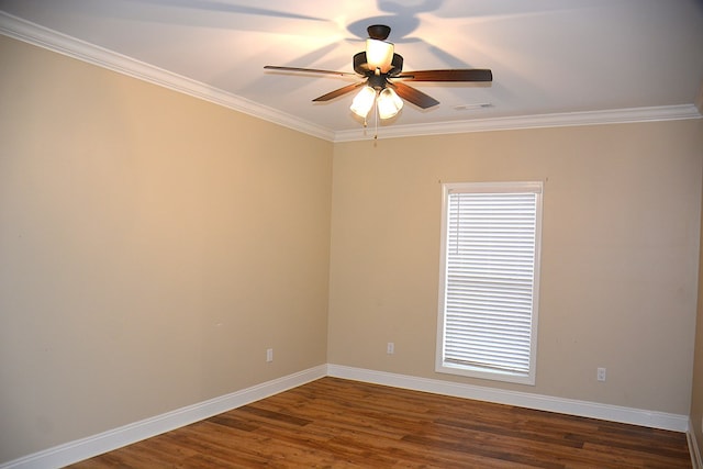 empty room with visible vents, dark wood-type flooring, ornamental molding, ceiling fan, and baseboards
