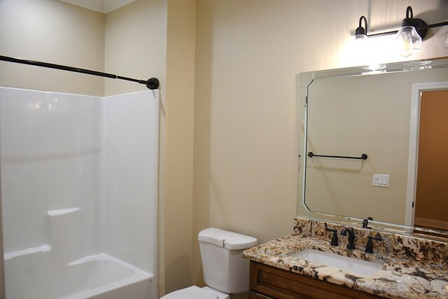 bathroom featuring  shower combination, vanity, and toilet