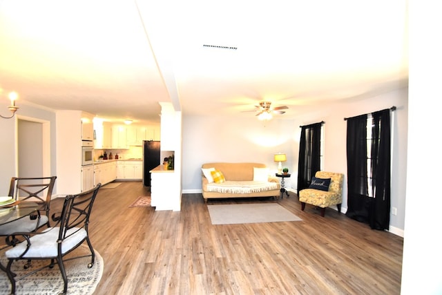 145 Deerpath St, Ozark, AL 36360 - living area featuring light wood finished floors and a ceiling fan