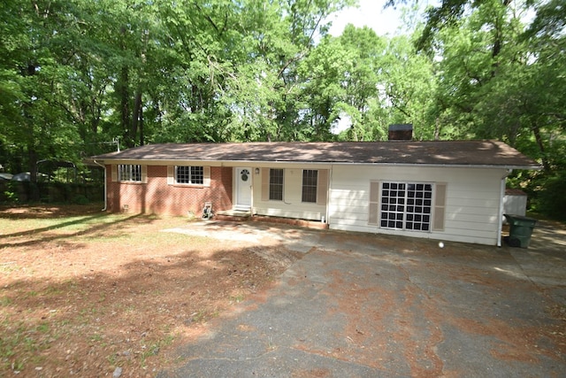 145 Deerpath St, Ozark, AL 36360 - ranch-style home with a chimney, asphalt driveway, and brick siding