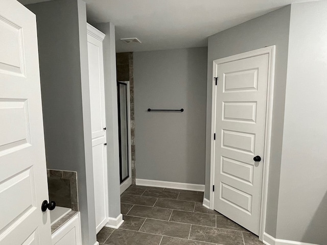 full bath with tile patterned floors, a stall shower, a bath, baseboards, and visible vents
